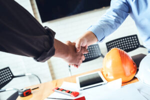 Business engineer team shaking hands to agree to joint business agreements in the future. About the creation of real estate and housing projects for government projects.