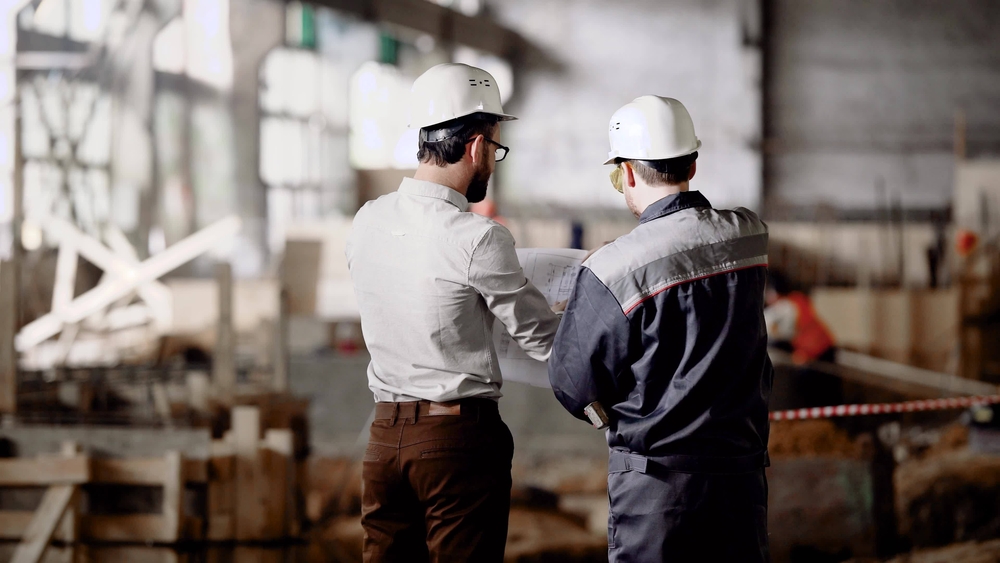 Architect and worker at the construction site.